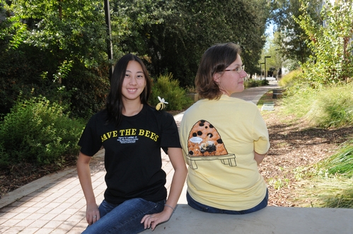 SPORTING the new honey bee t-shirts they created to raise funds for honey bee research at UC Davis are Nanase Nakanishi (left), an animal science major and a student employee at the Bohart Museum of Entomology, and Fran Keller, a doctoral student in entomology. Nanase models the front, and Fran, the back. (Photo by Kathy Keatley Garvey)