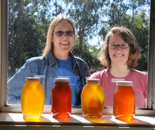 BEEKEEPERS outside the window of the Harry H. Laidlaw Jr. Honey Bee Research Facility at UC Davis. At left is bee breeder-geneticist Susan Cobey, manager of the Laidlaw Facility and a veteran beekeeper. With her is junior specialist Elizabeth Frost. (Photo by Kathy Keatley Garvey)