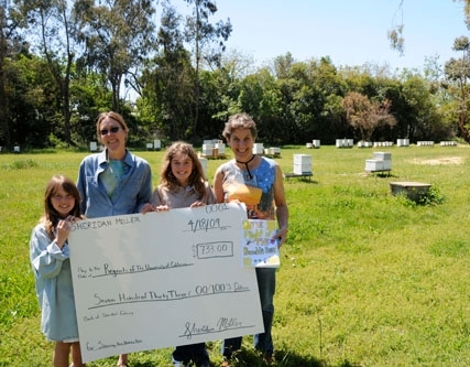 Holding the check for bee research (from left) are Annika Miller, then 8, who helped her big sister, Sheridan Miller, raise funds; bee breeder-geneticist Susan Cobey; Sheridan Miller; and Lynn Kimsey, then interim chair of the UC Davis Department of Entomology.