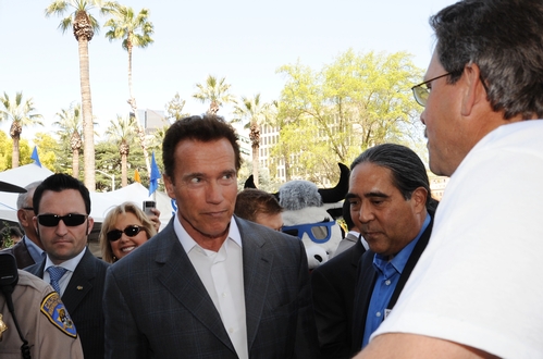 CALIFORNIA Gov. Arnold Schwarzenegger (center) and California Secretary of Agriculture A. G. Kawamura (right) listen to beekeeper Brian Fishback talk about the declining bee population.  (Photo by Kathy Keatley Garvey)