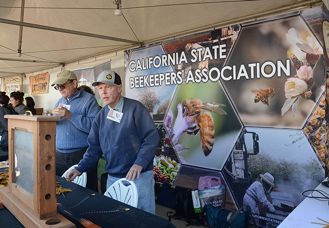 California State Beekeepers' Association secretary-treasurer Carlin Jupe (left) and member Bill Cervenka get ready to greet the crowds at Cal Ag Day. (Photo by Kathy Keatley Garvey)