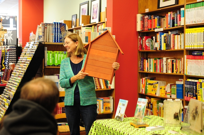 Rachael Long, in a presentation at the Avid Reader, shows a bat house. (Photo by Kathy Keatley Garvey)