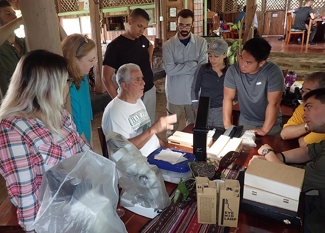 Entomologist Jeff Smith (center) who curates the moth and butterfly collection at the Bohart Museum of Entomology,   talks about butterflies at the Bohart's Belize summer expedition. (Photo by Steve Heydon)