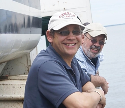 Blood brothers--medical entomologists Anthony Cornel (foreground) and Greg Lanzaro, who research malaria mosquitoes, are co-authors of a study published Sept. 15 in PLOS Genetics. This photo shows them on Lake Victoria in Kenya. (Photo by Steve Mulligan)