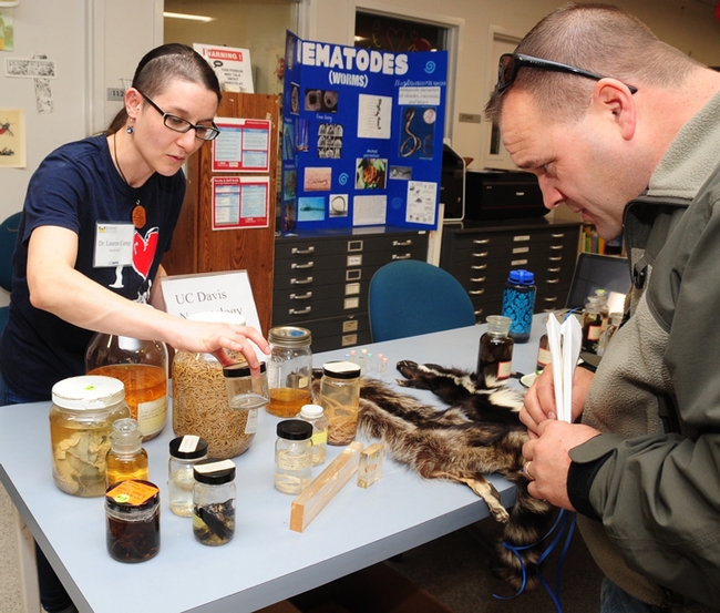 UC Davis nematologist/parasitologist Lauren Camp discusses her specialty with a visitor at the Bohart Museum's open house. (Photo by Kathy Keatley Garvey)
