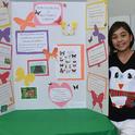 Selah Deuz of the Sherwood Forest 4-H Club, Vallejo, stands by her butterfly display board at the Solano County 4-H Project Skills Day. (Photo by Kathy Keatley Garvey)