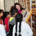 Tabatha Yang, education and outreach coordinator at the Bohart Museum of Entomology, shows butterfly specimens to a group of students. She received a Citation for Excellence from the UC Davis Staff Assembly for outstanding contributions. (Photos by Kathy Keatley Garvey)