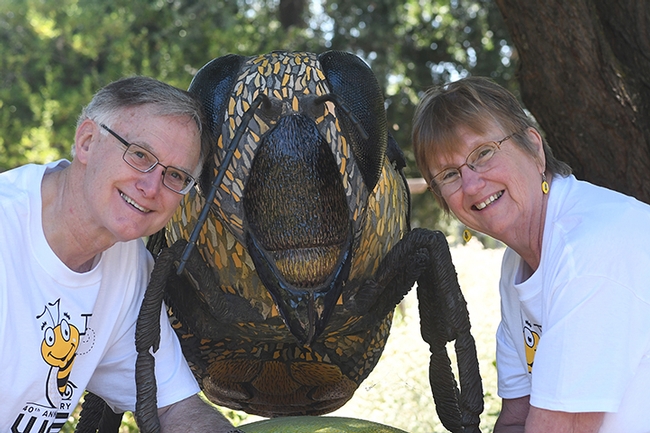 The Bee Team: Eric Mussen, WAS president, and his wife, Helen, his assistant in planning the WAS program. They are pictured by Miss Bee Haven, a sculpture by Donna Billick that anchors the Häagen Dazs Bee Haven. A tour of the garden is planned during the Sept. 5-8 conference. (Photo by Kathy Keatley Garvey)