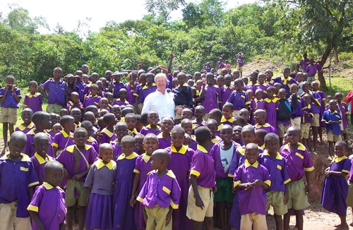 In KENYA--Professor Thomas Scott of the UC Davis Department of Entomology researches mosquito-borne diseases. Here he's shown in Kenya in 2004 with a group of young children.  The Entomological Society of America (ESA) announced today that Scott is one of the 10 newly elected ESA Fellows. Other UC entomology professors selected: Bruce Hammock of UC Davis and Thomas Miller of UC Riverside.