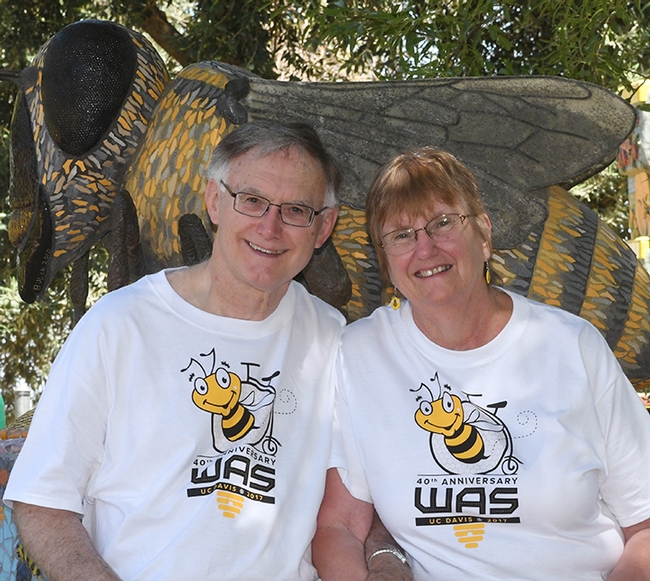 Eric Mussen, WAS president, and his wife, Helen, who is assisting him in his presidency, sit next to Miss Bee Haven, a sculpture that anchors the Häagen Dazs Bee Haven at UC Davis. The sculpture is the work of Donna Billick. (Photo by Kathy Keatley Garvey)
