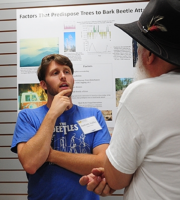 UC Davis doctoral student Jackson Audley discusses bark beetles at a recent bark beetle open house, coordinated by Steve Seybold, at the Bohart Museum of Entomology. (Photo by Kathy Keatley Garvey)