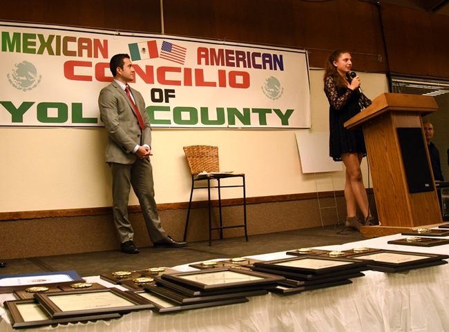 Davis High School scholar Helena Leal addresses the crowd at the Mexican-American Yolo County Concilio Scholarship Dinner. At left is keynote speaker Carlos Saucedo of ABC Channel 10.(Photo by Kathy Keatley Garvey)