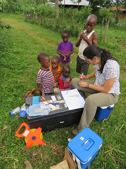 Katja Poveda (left), assistant professor of entomology at Cornell, doing field work in Kenya.