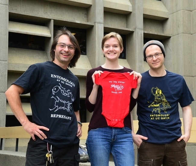 UC Davis Entomology Graduate Student Association (EGSA) offers t-shirts year-around and they're especially popular during the hoidays. From left are president Brendon Boudintot, t-shirt coordinator Jill Oberski and Corwin Parker with their award-winning shirts. (Photo by Kathy Keatley Garvey)
