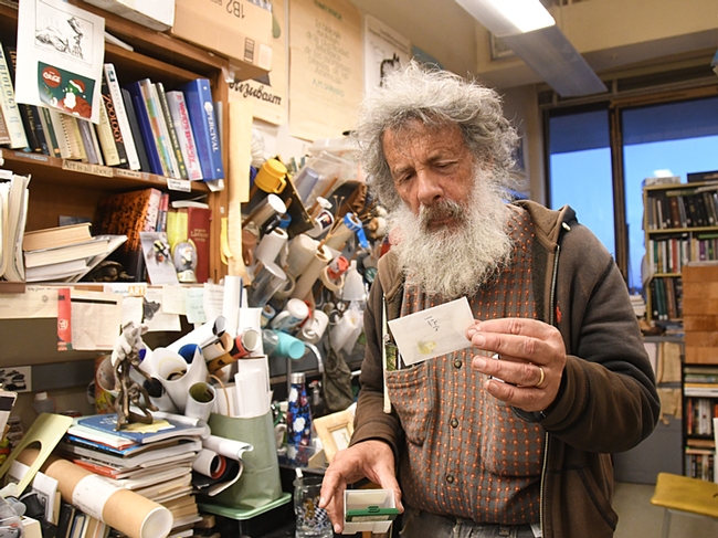 Art Shapiro, UC Davis distinguished professor of evolution and ecology, holds a glassine envelope containing the winner of the 2019 Beer-for-a-Butterfly Contest. (Photo by Kathy Keatley Garvey)