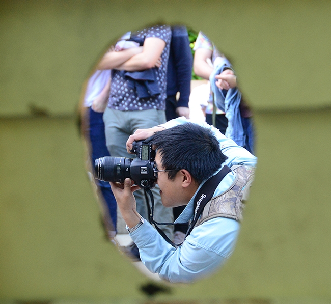 UC Davis Picnic Day offers a lot of photo opportunities. Here Alex Nguyen, an entomology graduate, focuses on the 