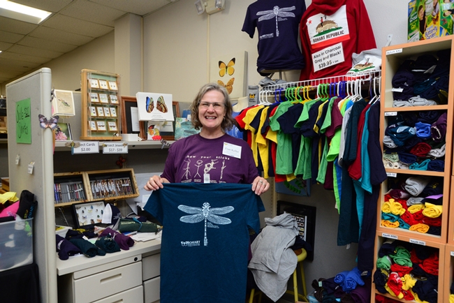 Bohart associate Fran Keller, an assistant professor at Folsom Lake College and a UC Davis alumnus (she received her doctorate in entomology studying with Lynn Kimsey) holds some of the new dragonfly t-shirts available at the Bohart Museum. (Photo by Kathy Keatley Garvey)