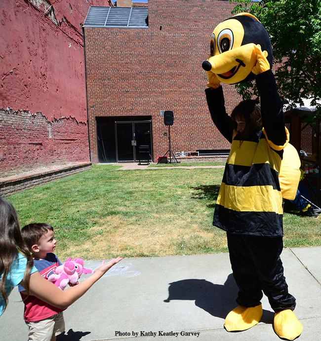 Can you remove your head? This little boy was delighted when Ms. Queen Bee did. (Photo by Kathy Keatley Garvey)