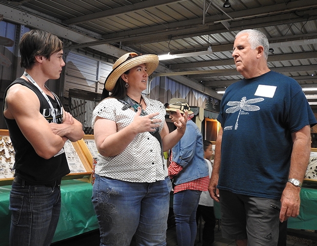 Entomologists Alex Dedon (left) and Jeff Smith of UC Davis engage with Carolyn Jones of Dixon, who served as chair of the 2019 Sacramento Orchid Show. (Photo by Kathy Keatley Garvey)