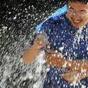 Wei Xu, of chemical ecologist Walter Leal's lab, gets drenched. (Photo by Kathy Keatley Garvey)
