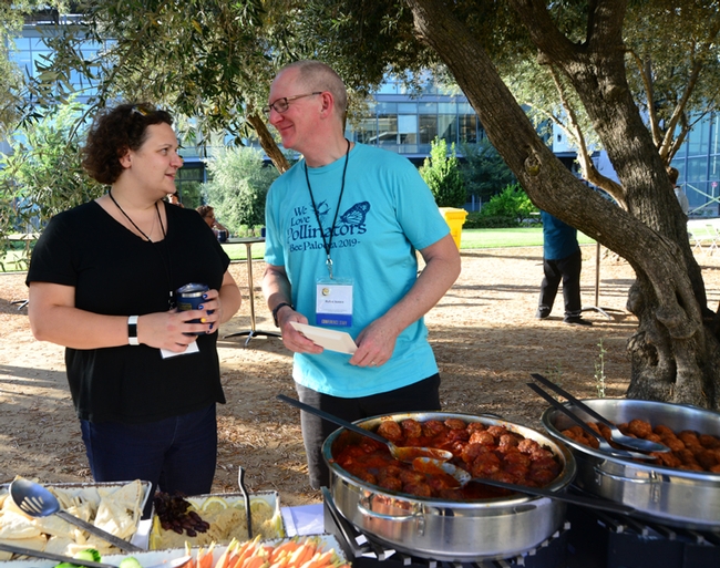 Extension piculturist Elina Lastro Niño of the UC Davis Department of Entomology and Nematology chats with the International Pollinator Conference co-founder Rufus Isaacs of Michigan State University at the Thursday reception. (Photo by Kathy Keatley Garvey)