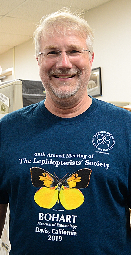 Society president Brian Scholtens, a professor at the College of Charleston, South Carolina, wears the conference t-shirt. (Photo by Kathy Keatley Garvey)