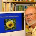 Robbin Thorp, distinguished emeritus professor of entomology at UC Davis, with his screensaver, an image he took of Franklin's bumble bee. He passed June 7. (Photo by Kathy Keatley Garvey)