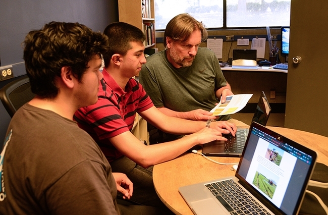 The UC Davis Smart Spray team working on their project: (from left) Gabriel Del Villar and Alexander Recalde and agricultural entomologist Christian Nansen. (Photo by Kathy Keatley Garvey)