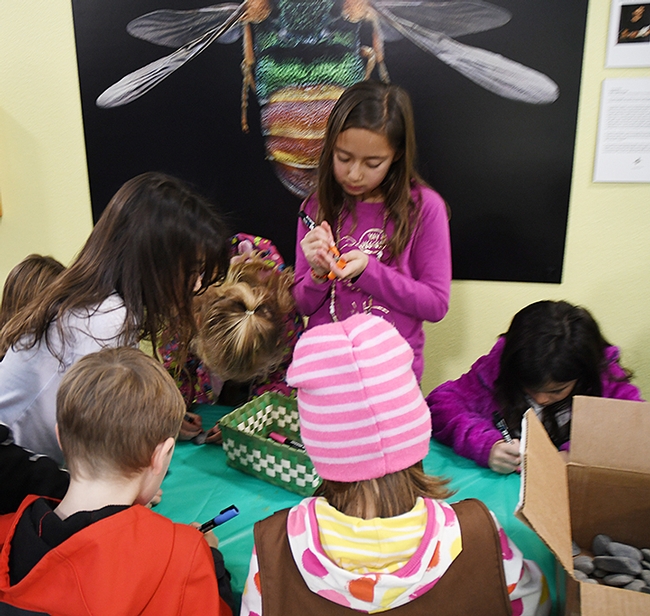 Youngsters flocked to the rock painting table at the Bohart Museum of Entomology to create their masterpieces. (Photo by Kathy Keatley Garvey)
