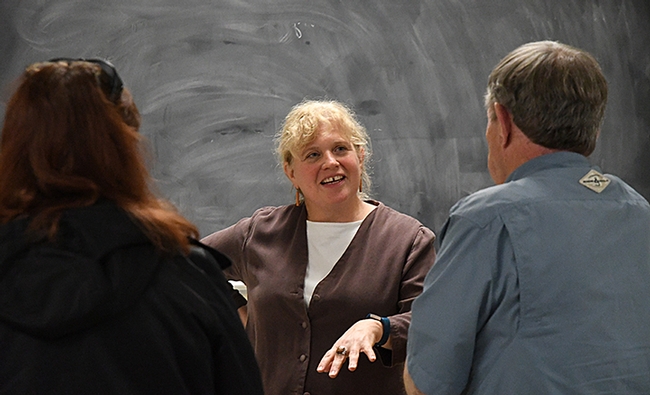 Professor Elizabeth Crone chats with scientists following her talk. (Photo by Kathy Keatley Garvey)