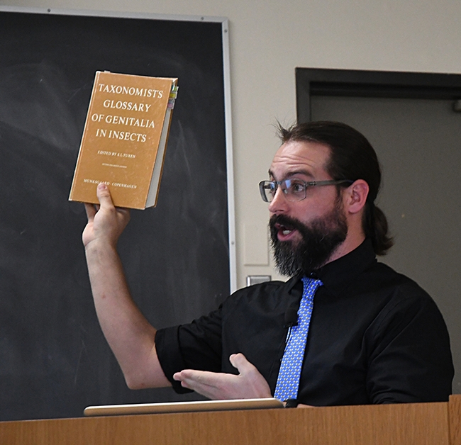 Ant specialist Brendon Boudinot recommends one of his dog-eared textbooks. (Photo by Kathy Keatley Garvey)
