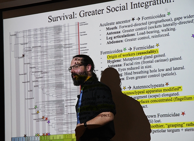 Text of Brendon Boudinot's PowerPoint slides onto his face. (Photo by Kathy Keatley Garvey)