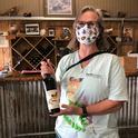 Professor Fran Keller of Folsom Lake College with a bottle of Dogface Cabernet Sauvignon produced by Lone Buffalo Vineyards and Winery, Auburn. Sales of the wine help conservation efforts of Placer Land Trust to protect the butterfly, the California state insect.