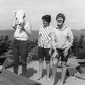 Lynn Siri (far right), now  UC Davis professor Lynn Kimsey, laughs with her sister, Anne, as their mother, Jean Siri, tries on a skull.