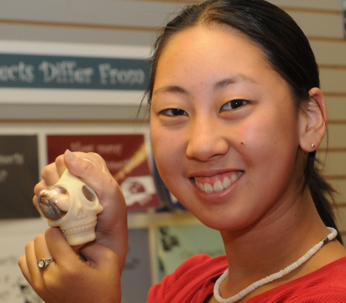 Squeeze this stress ball and out will pop either assorted bugs, worms, frogs or rats. Nanase Nakanishi, a UC Davis student majoring in animal science, and an employee at the Bohart Museum of Entomology, displays what it does. (Photo by Kathy Keatley Garvey)