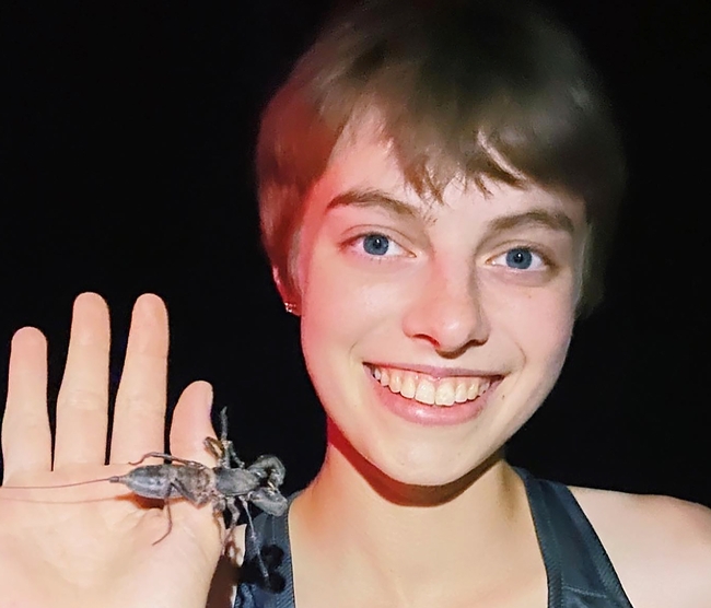 UC Davis entomology major Gwen Erdosh with a vinegaroon, also known as a whip scorpion. She collected the scorpion in Tucson.