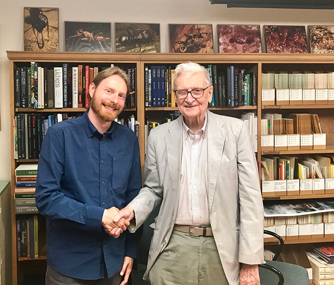 Marek Borowiec (left) shakes hands with E. O. Wilson at the Harvard Museum of Comparative Zoology (MCZ). Borowiec went on to receive his doctorate in entomology from UC Davis and is now an assistant professor at the University of Idaho.