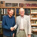 Marek Borowiec (left) shakes hands with E. O. Wilson at the Harvard Museum of Comparative Zoology (MCZ). Borowiec went on to receive his doctorate in entomology from UC Davis and is now an assistant professor at the University of Idaho.