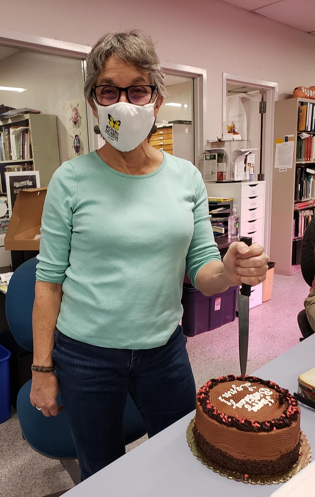 Lynn Kimsey, director of the Bohart Museum of Entomology, prepares to cut her birthday cake. (Photo by Tabatha Yang)