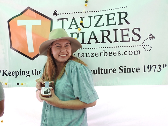 Claire Tauzer of Tauzer Apiaries/Sola Bee Farms welcomes the crowd. (Photo by Kathy Keatley Garvey)
