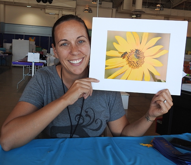Heather DeGroot displays an image of a syrphid fly and honey bee, the work of 17-year-old Matthew Agbayani of the Vaca Valley 4-H Club, Vacaville.(Photo by Kathy Keatley Garvey)