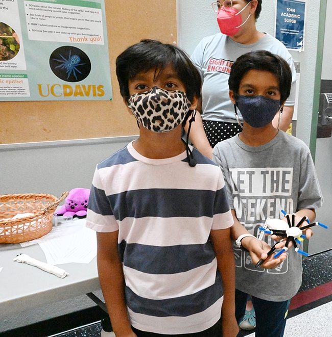 Nine-year-old twins Vedant (left) and Siddharth Revo of San Jose participated in all the activities at the open house. Siddharth is holding a spider he crafted.(Photo by Kathy Keatley Garvey)
