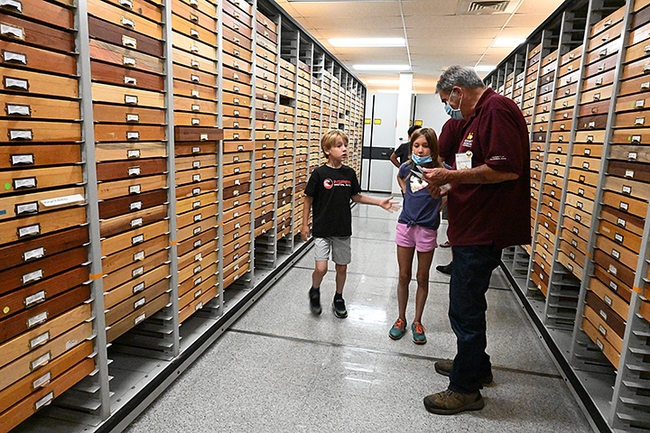 Niccoli Zebouni, 7, and his sister Clio, 9, rush to greet Bohart associate Greg Kareofelas to learn more about butterflies. (Photo by Kathy Keatley Garvey)