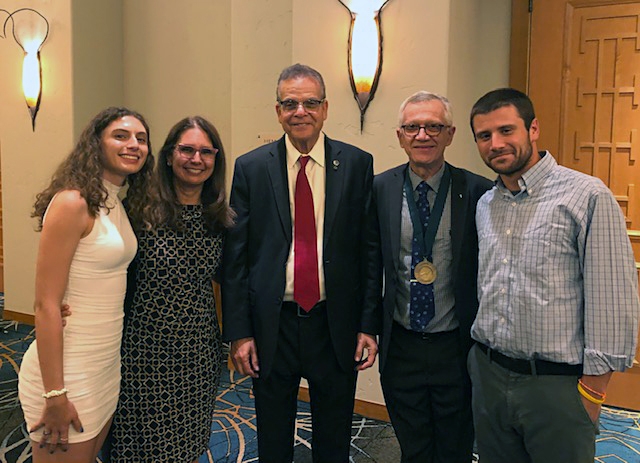 NAI president Paul Sanberg (center) with Walter Leal and his family. Pictured are his wife Beatriz;  daughter Helena; and son Gabriel. Both siblings authored papers while in the Leal lab. Gabriel is now a law office clerk and Helena is an UX designer with Amazon. Not pictured is son Gabriel. (Courtesy Photo)