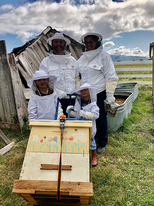 Kaycee, a first-year 4-H beekeeper with her family. (Photo by Ettamarie Peterson)