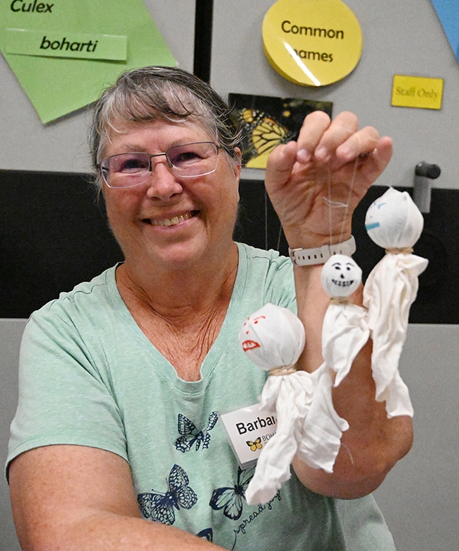 UC Davis student and Bohart volunteer Elizabeth Gromfin, who staffed the gall ghost table, holds a few of the ghosts she made. (Photo by Kathy Keatley Garvey)



Bohart associate Barbara Heinsch of Davis helped with the arts-and-crafts table. Here she shows some of the gall ghosts she created. (Photo by Kathy Keatley Garvey)