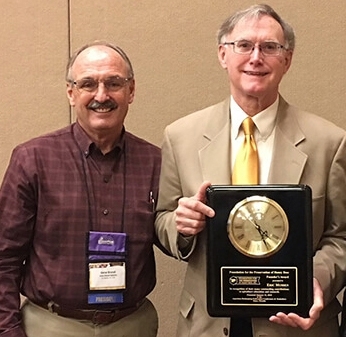Gene Brandi (left) served as the emcee at the CSBA luncheon memorializing Eric Mussen. Here, as the 2018 president of the Foundation for the Preservation of Honey Bees, he presents the Founders' Award to Mussen.