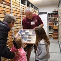 Entomologist Jeff Smith, curator of the Lepidoptera collection at the Bohart Museum, shows visitors some of the specimens. (Photo by Kathy Keatley Garvey)