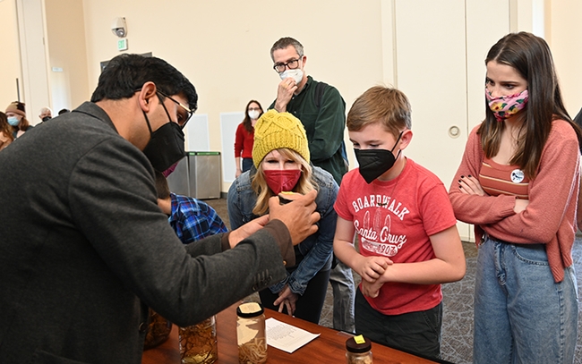 Nematologist Shahid Siddique explains some of the display items during a previous UC Davis Biodiversity Museum Day. (Photo by Kathy Keatley Garvey)