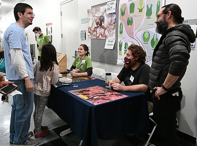 UC Davis doctoral alumnus Brendon Boudinot (foreground), now an Alexander von Humboldt Research Fellow at the Institute of Zoology and Evolutionary Research at Friedrich Schiller University Jena, answers questions at the UC Davis Biodiversity Museum Day. Seated are doctoral candidate Jill Oberski and graduate student Ziv Lieberman of the Phil Ward lab. In back is doctoral candidate Zachary Griebenow. (Photo by Kathy Keatley Garvey)